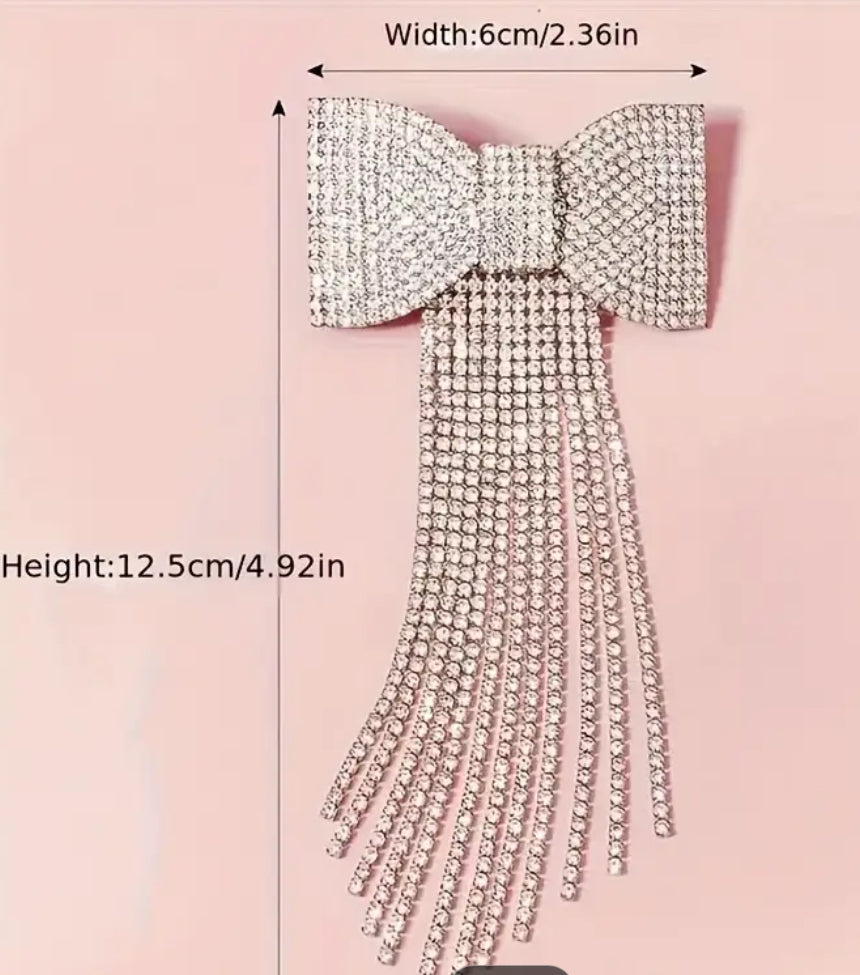 Beautiful bow hair clip with hang down sparkles.