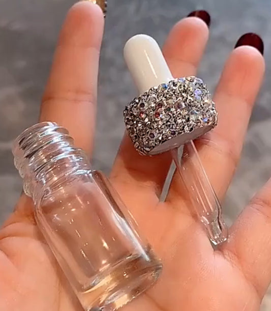 Rhinestone dropper for oil or perfume.